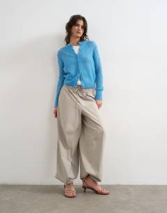 Model wearing Lightwieght pointelle cardigan in blue 