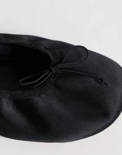Model wearing Lila round toe ballet flat in black satin