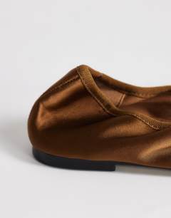 Model wearing Lila round toe ballet flat in bronze satin