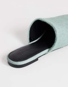 Model wearing Lillie real hair on leather round toe flat shoe in aqua