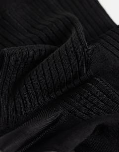 Model wearing Lillie ribbed socks in black