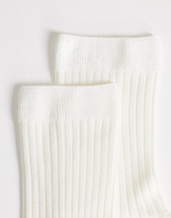 Model wearing Lillie ribbed socks in off white
