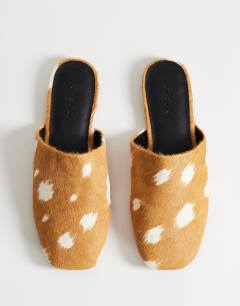 Model wearing Lillie round toe flat shoe in deer print hair on real leather 