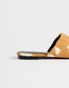 Model wearing Lillie round toe flat shoe in deer print hair on real leather 
