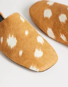 Model wearing Lillie round toe flat shoe in deer print hair on real leather 