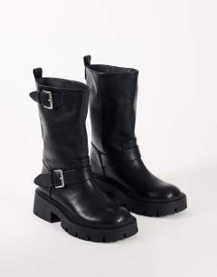 Model wearing Lincon chunky mid calf boot with buckles in black