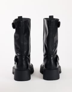 Model wearing Lincon chunky mid calf boot with buckles in black
