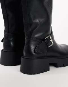 Model wearing Lincon chunky mid calf boot with buckles in black
