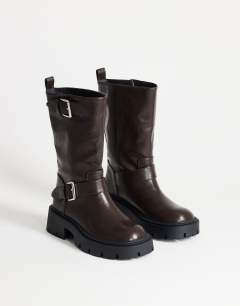 Model wearing Lincon chunky mid calf boot with buckles in choc