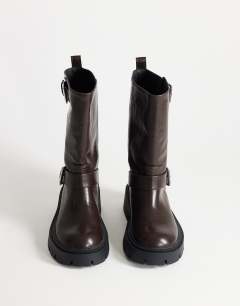 Model wearing Lincon chunky mid calf boot with buckles in choc