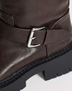 Model wearing Lincon chunky mid calf boot with buckles in choc