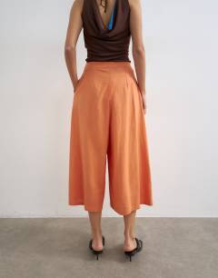 Model wearing Linen A line culotte in washed orange