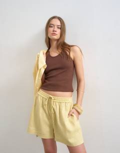 Model wearing Linen A line short in yellow