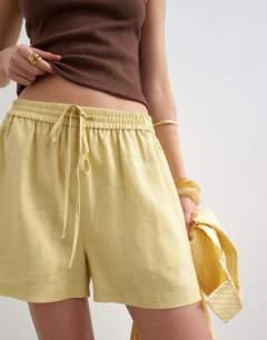 Model wearing Linen A line short in yellow