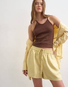 Model wearing Linen A line short in yellow