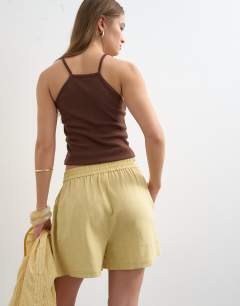 Model wearing Linen A line short in yellow