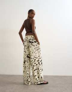 Model wearing Linen balloon trouser with tie waist in cow print