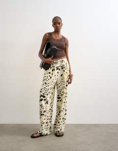 Model wearing Linen balloon trouser with tie waist in cow print