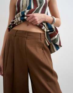 Model wearing Linen barrel leg trouser in brown