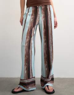 Model wearing Linen blue painted stripe straight leg trouser with deep cuff in blue