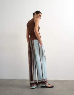 Model wearing Linen blue painted stripe straight leg trouser with deep cuff in blue