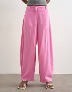 Model wearing Linen clean tie waist barrel trouser in pink