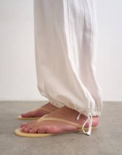 Model wearing Linen elasticated waist balloon trouser in white