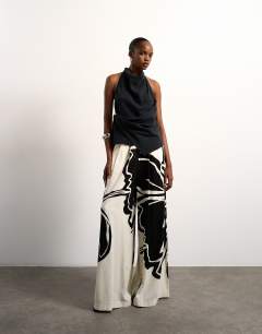 Model wearing Linen floral placement wide leg trouser in ecru