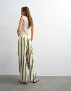 Model wearing Linen green stripe clean tie waist barrel trouser in green