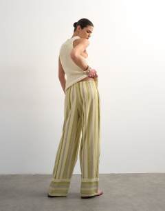 Model wearing Linen multi stripe straight trouser in green