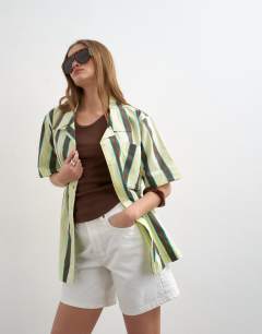 Model wearing Linen resort shirt in lime and chocolate stripe
