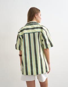 Model wearing Linen resort shirt in lime and chocolate stripe