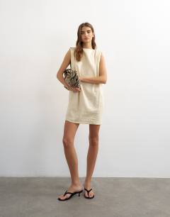 Model wearing Linen rich exaggerated shoulder mini dress in beige