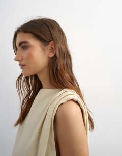Model wearing Linen rich exaggerated shoulder mini dress in beige