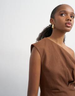 Model wearing Linen rich fallen shoulder mini dress with tucked waist in chocolate