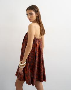 Model wearing Linen rich full trapeze bandeau mini dress in rust boutique scarf print