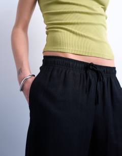 Model wearing Linen straight leg trouser with deep cuff in black