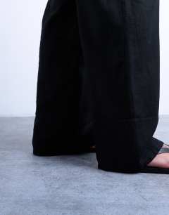 Model wearing Linen straight leg trouser with deep cuff in black