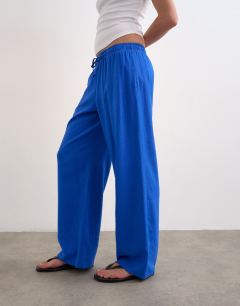 Model wearing Linen straight leg trouser with deep cuff in cobalt