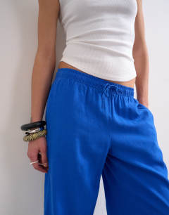 Model wearing Linen straight leg trouser with deep cuff in cobalt