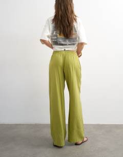 Model wearing Linen straight leg trouser with deep cuff in mid green