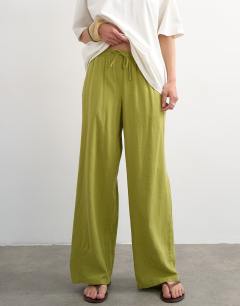 Model wearing Linen straight leg trouser with deep cuff in mid green