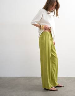 Model wearing Linen straight leg trouser with deep cuff in mid green