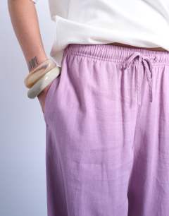 Model wearing Linen straight leg trouser with deep cuff in purple