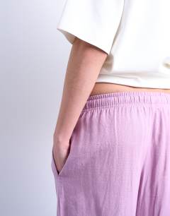 Model wearing Linen straight leg trouser with deep cuff in purple