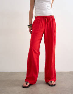 Model wearing Linen straight leg trouser with deep cuff in red