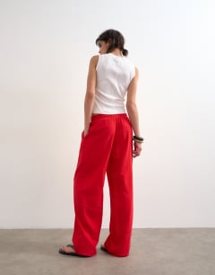Model wearing Linen straight leg trouser with deep cuff in red