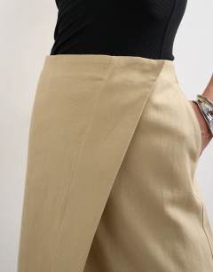 Model wearing Linen wrap maxi skirt in taupe