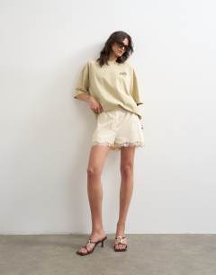 Model wearing Little Italy graphic oversized tee in stone