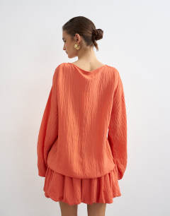 Model wearing Long sleeve blouson mini dress in bright coral